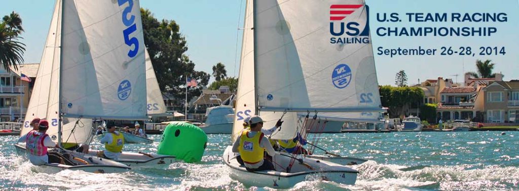 Four small sailboats with teams racing near a green buoy in a sunny harbor, with houses and palm trees in the background. Overlay text reads 'U.S. Team Racing Championship, September 26-28, 2014.