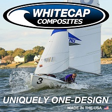 A sailboat with the number 3 races on a lake as two sailors lean out. The 'Whitecap Composites' logo is above, with the text 'Uniquely One-Design' and 'Made in the USA' at the bottom.