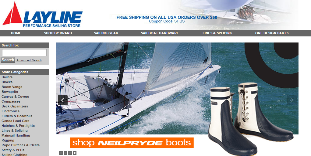 A sailboat racing on blue water is shown in the background, with a close-up of sailing boots in the foreground. The website header reads “LAYLINE PERFORMANCE SAILING STORE,” and navigation and shopping options are visible.