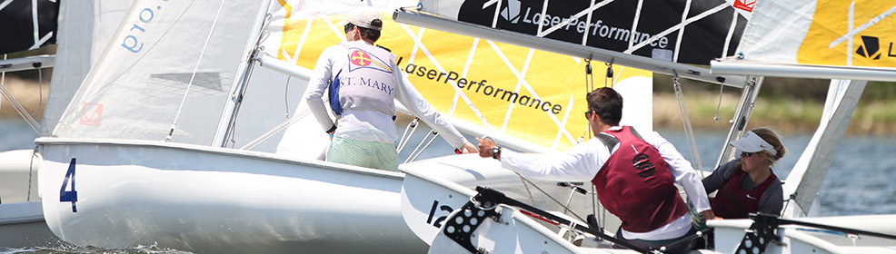 Three people sailing in small boats during a regatta, with sails marked 'LaserPerformance.' The sailors wear life vests and caps, and the boats are close together on the water.
