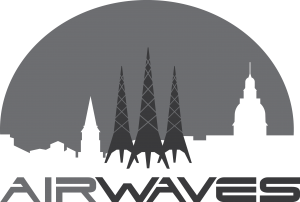 A grayscale logo featuring three radio towers in front of a city skyline with various building silhouettes and a large semi-circle in the background. The word "AIRWAVES" appears below in bold, modern font.