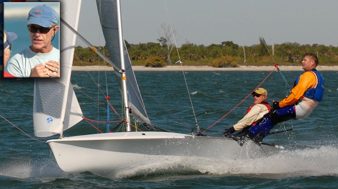 Two people sail a small white racing sailboat at high speed, leaning out over the water. Inset: close-up of a man in a blue shirt, sunglasses, and cap talking outdoors. Trees and shoreline are visible in the background.