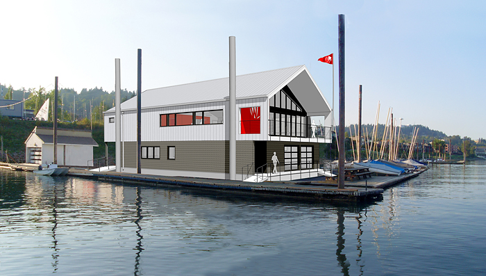 A modern two-story floating building with a gray and white exterior and red accents sits on a dock over calm water, surrounded by sailboats and a wooded shoreline in the background.
