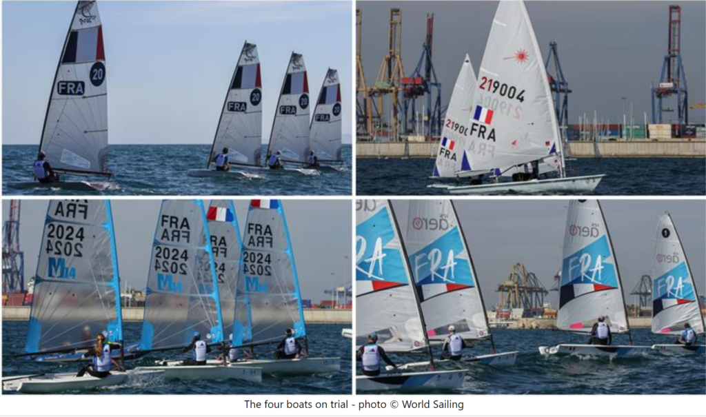 Four sailboats race on the ocean near a port with large cranes, under a partly cloudy sky. The boats have visible sail numbers and country codes, and multiple sailors can be seen maneuvering them.