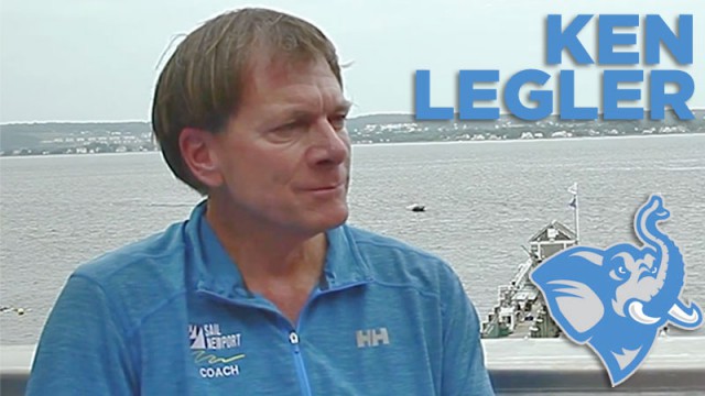 A man in a blue 'Sail Newport Coach' shirt sits by the water with a dock in the background. Large text reads 'KEN LEGLER' and there is a blue elephant logo in the lower right corner.