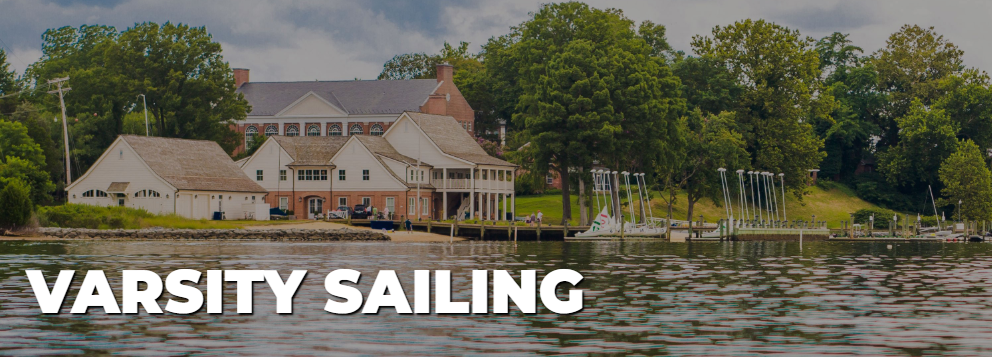 A boathouse and dock with sailboats on a calm waterfront, surrounded by trees, with "VARSITY SAILING" in bold white text in the foreground.