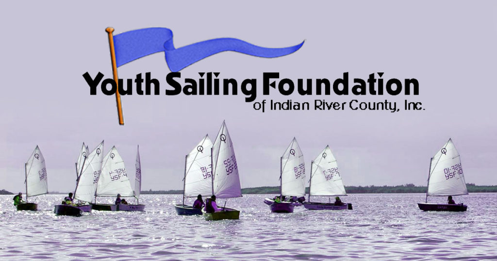 A group of small sailboats with young sailors on the water, beneath the logo for the Youth Sailing Foundation of Indian River County, Inc., featuring a blue flag.