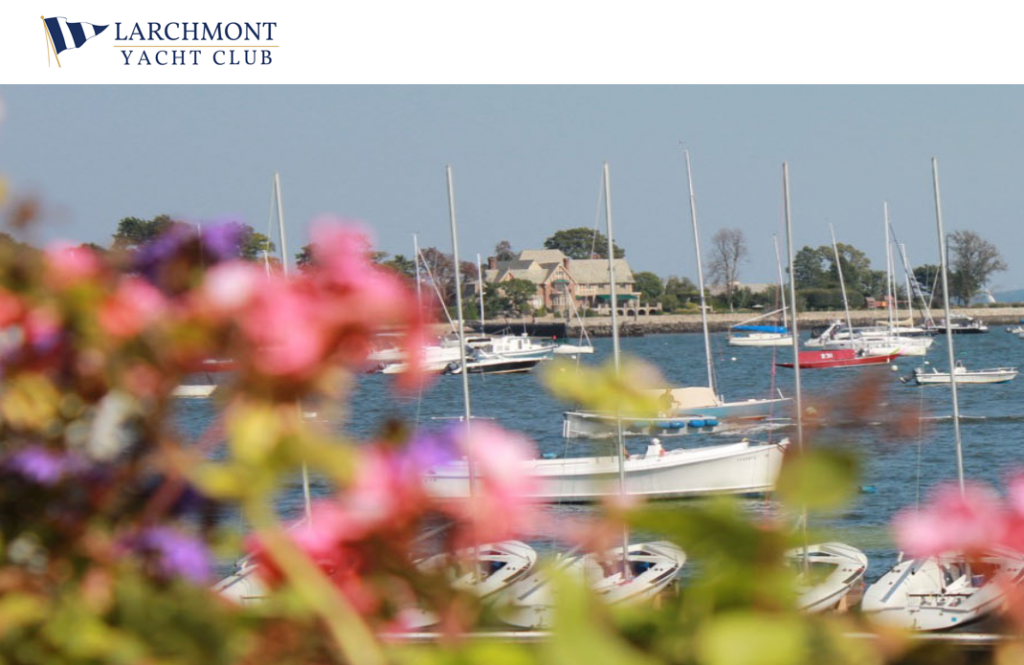 A view of sailboats docked on calm water, with colorful flowers in the foreground and the Larchmont Yacht Club logo in the top left corner. Trees and a waterfront house are visible in the background.