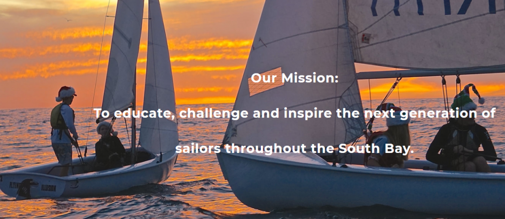 Two sailboats with young sailors float on calm water at sunset, with an orange sky in the background. White text in the center reads: 'Our Mission: To educate, challenge and inspire the next generation of sailors throughout the South Bay.