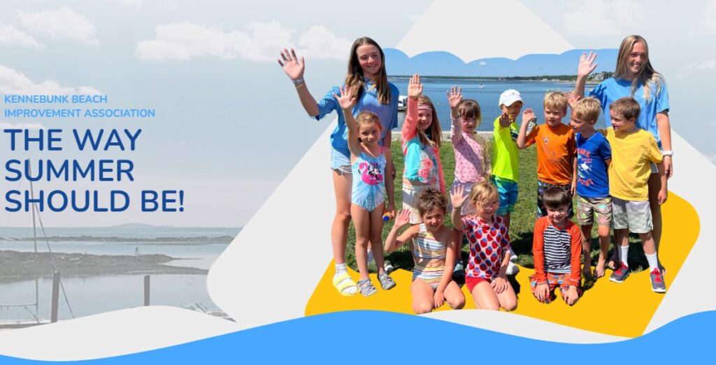 A group of smiling children and two adults stand on green grass, waving at the camera. Behind them is a blue sky and water. Text on the left reads, 'KENNEBUNK BEACH IMPROVEMENT ASSOCIATION – THE WAY SUMMER SHOULD BE!.