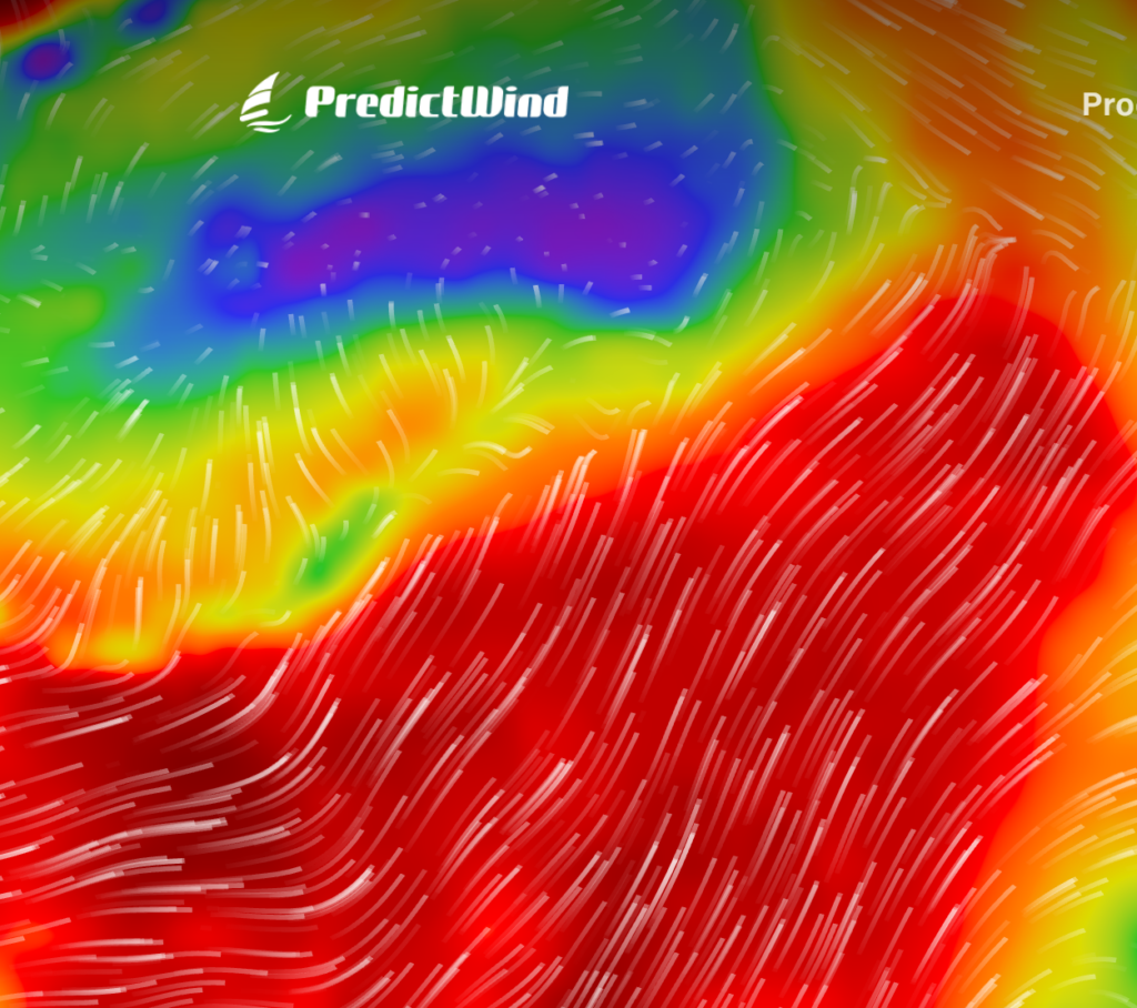 A colorful wind map from PredictWind shows wind patterns with white arrows over red, yellow, green, blue, and purple zones, indicating different wind speeds and directions across the region.