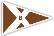 A triangular pennant flag with a brown background, white border, and a white diagonal 'X' shape. The letter 'B' is centered in brown over the intersection of the 'X.