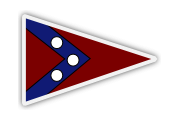 A triangular pennant flag with a red background, bordered in white. A blue chevron pointing right contains three white circles evenly spaced along the chevron.