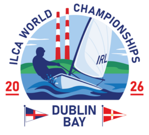 Logo for the ILCA World Championships 2026, featuring a sailboat with "IRL" on the sail, a sailor, waves, and two red-and-white chimneys in the background, with "Dublin Bay" and two nautical flags below.