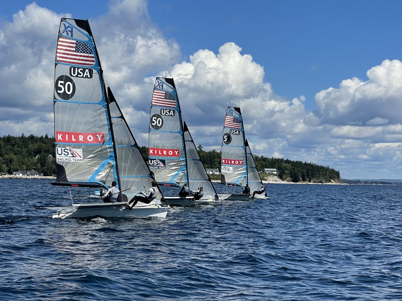 Three sailboats with American flags and 